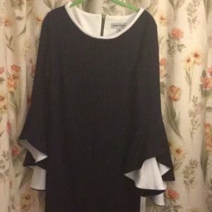 Women’s black dress with huge white bell sleeves